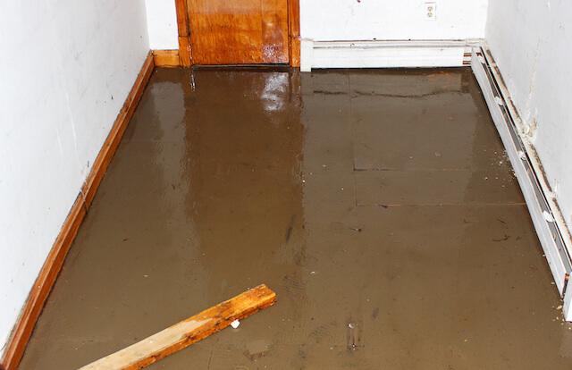 basement flooding vancouver technician installing backwater valve