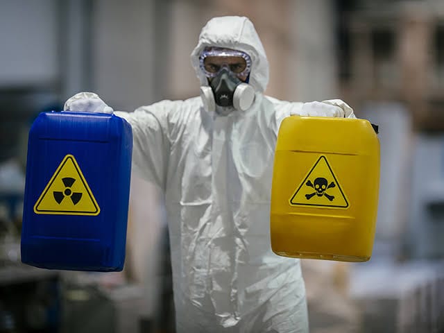 biohazard cleanup technician in hazmat suit preparing for job