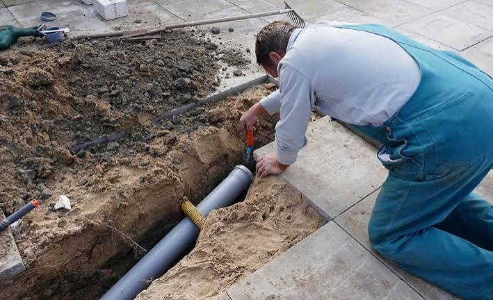 sewage backup cleanup technician assessing contaminated water in basement
