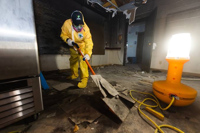 fire damage restoration technician assessing burned room