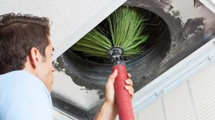 air duct cleaning after water damage technician inspecting vent